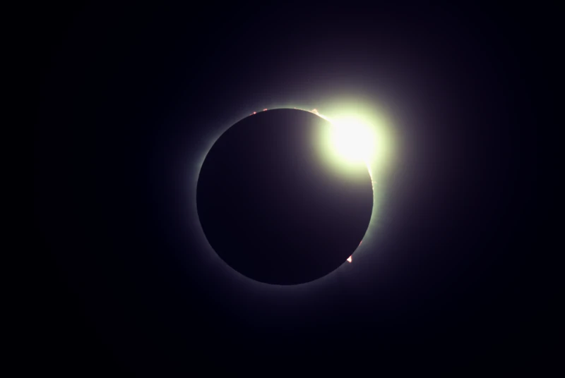 A larger diamond ring as more of the sun emerges from behind the moon